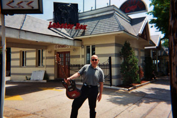 Lobster w/Bass Guitar ready to rock outside The Lobster Box restaurant at City Island, Bronx NY-May 2004.